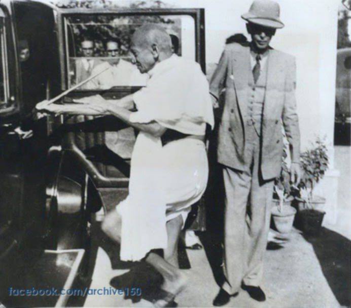 c. 1939: Quaid holds the car door for Mahatma Gandhi, en route to the Viceroy's Palace in Dehli. They conferred with the viceroy regarding India's demand for dominion status in return for support of Britain's War against Germany. PHOTO: Archive150